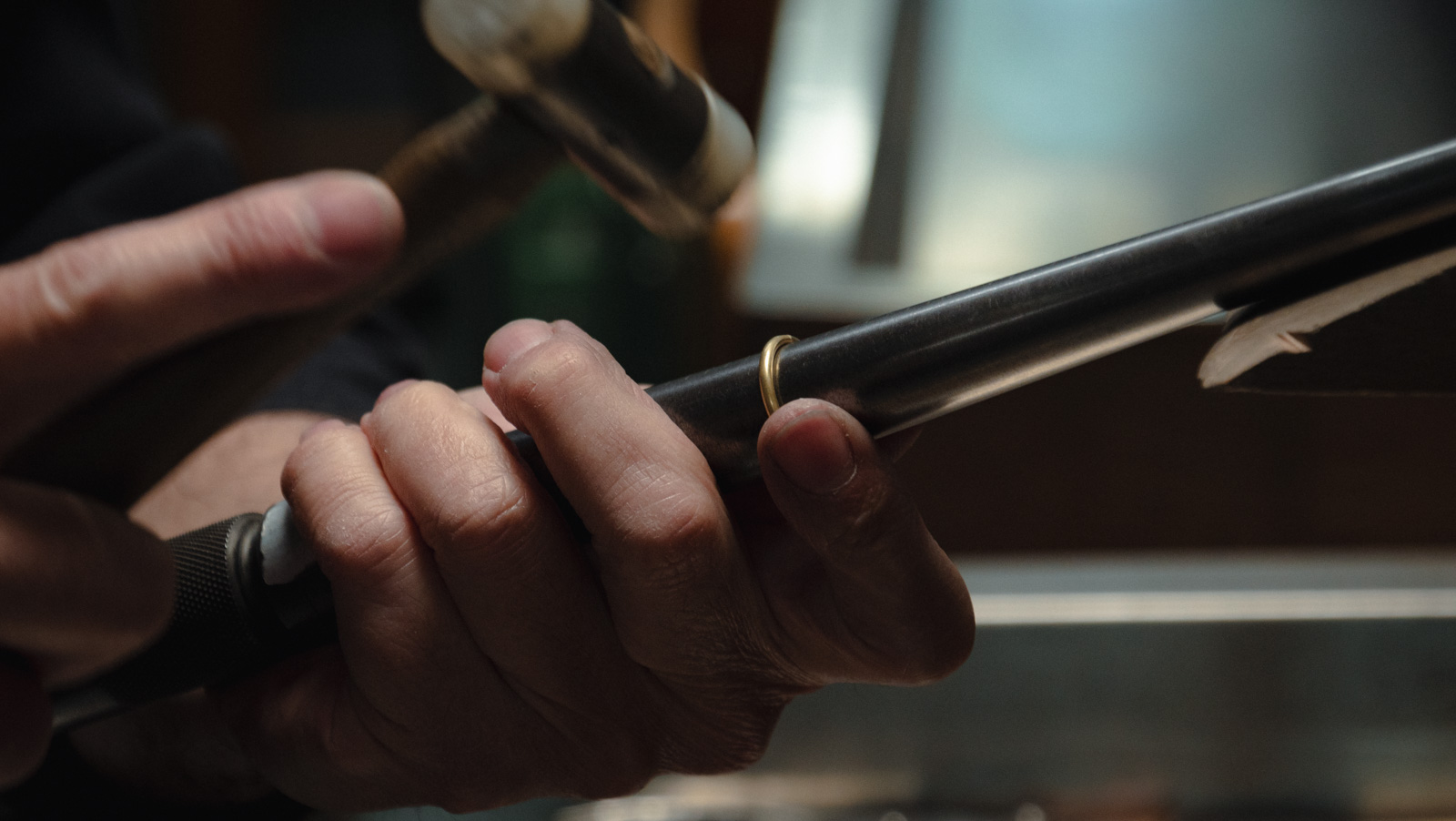 Master jeweller inspecting a diamond setting — Goldsmith